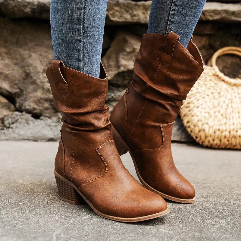 Women's tan leather western slouch boots mid-calf height with relaxed pull-on silhouette
