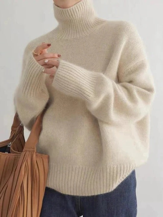 Ivory turtleneck sweater with smooth uniform knit, minimalist silhouette, and close flexible fit