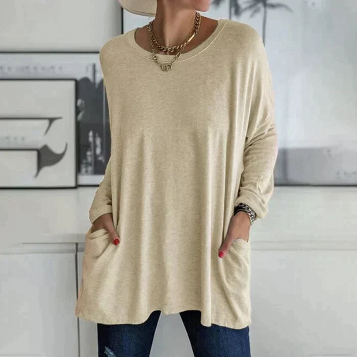 Women's oversized long sleeve tunic top with front pockets, relaxed knit fit and flared hem