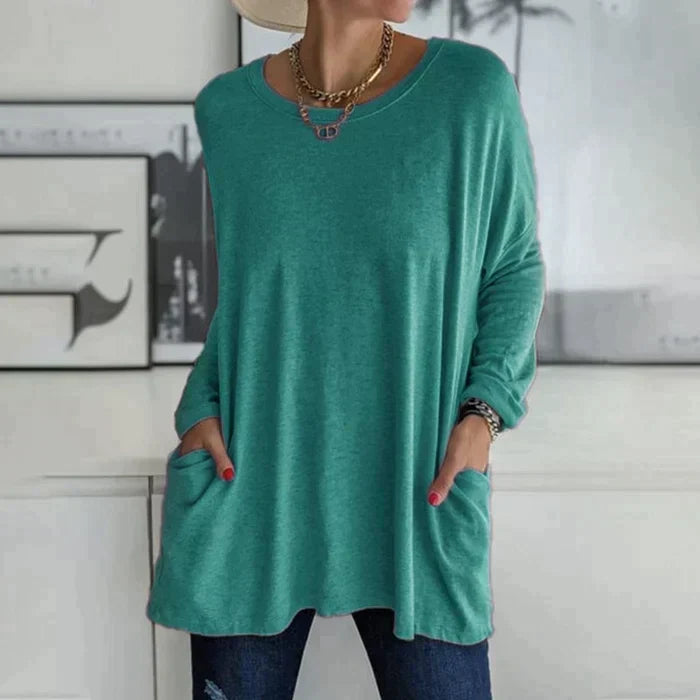 Women's oversized long sleeve tunic top with front pockets, relaxed knit fit and flared hem