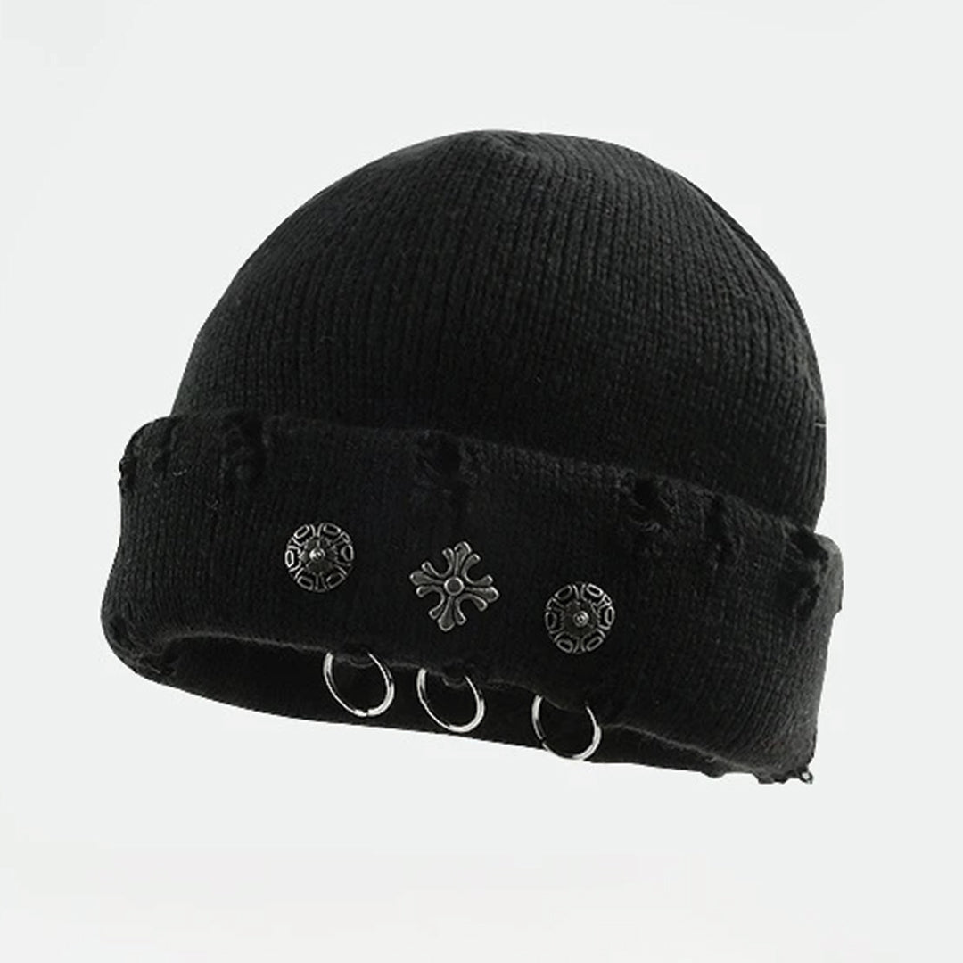 Black knit beanie with cross piercing hardware accents and distressed cuff edge, edgy streetwear style