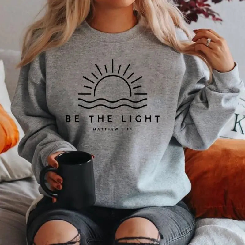 White women's pullover sweatshirt with minimalist Matthew 5:14 scripture print Be The Light