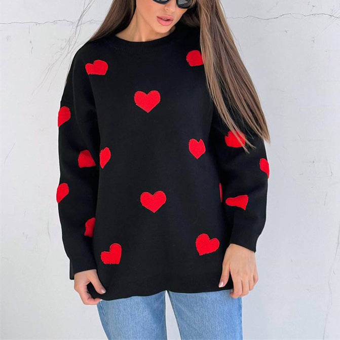 Women's oversized knit sweatshirt in neutral tone with woven red heart pattern, cozy casual fit