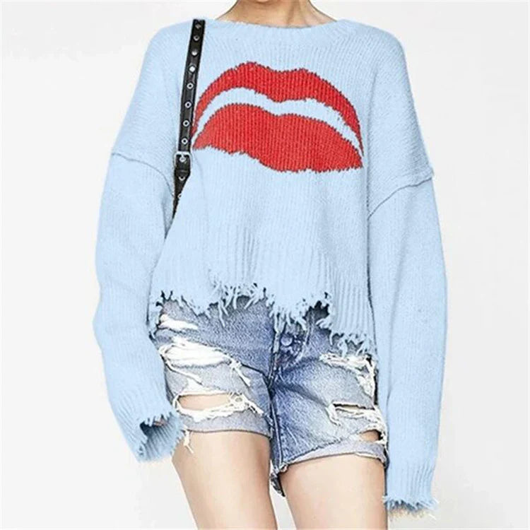 Women's chunky knit wool oversized cropped sweater with lip motif and fringed hem in cozy fall style