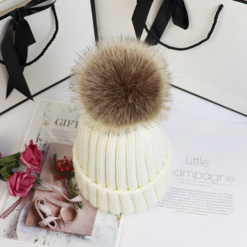 Cozy classic knit beanie with fluffy pom-pom accent, snug fit, neutral winter style