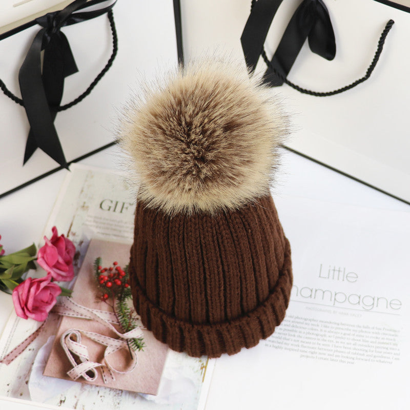 Classic cozy knit beanie with fluffy pom accent in neutral tone, snug feminine winter style