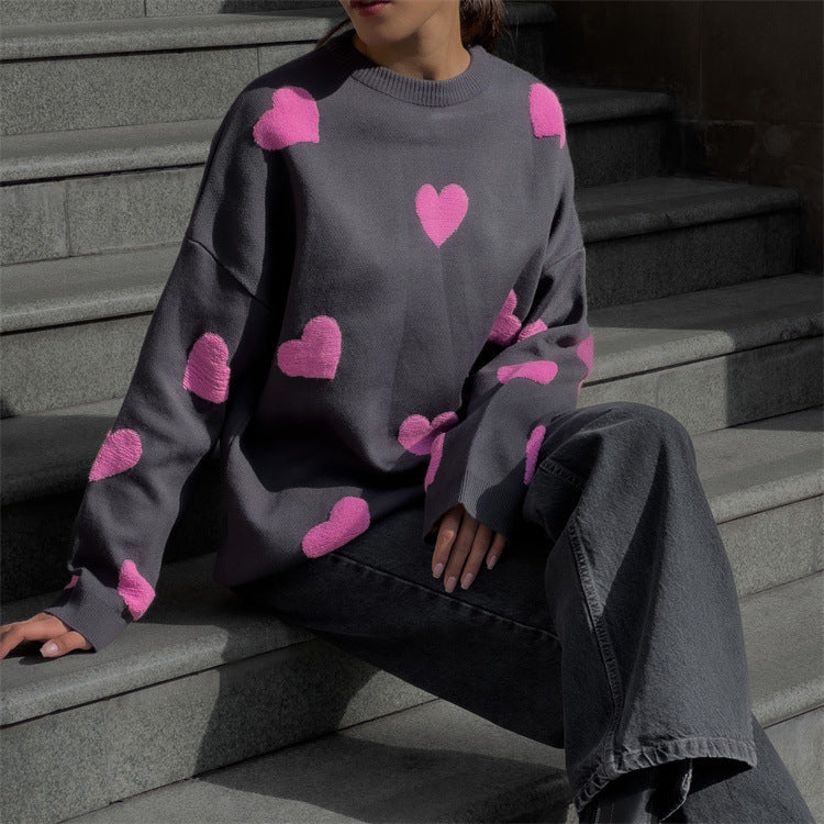 Women's oversized knit sweatshirt in neutral tone with red heart pattern, cozy casual fit