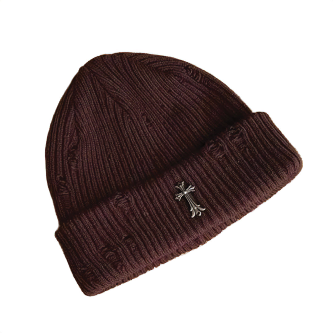 Black ribbed knit beanie with distressed finish and iron cross metal emblem, street style