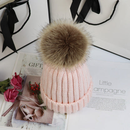 Classic cozy knit beanie with fluffy pom accent in neutral tone, snug feminine winter style