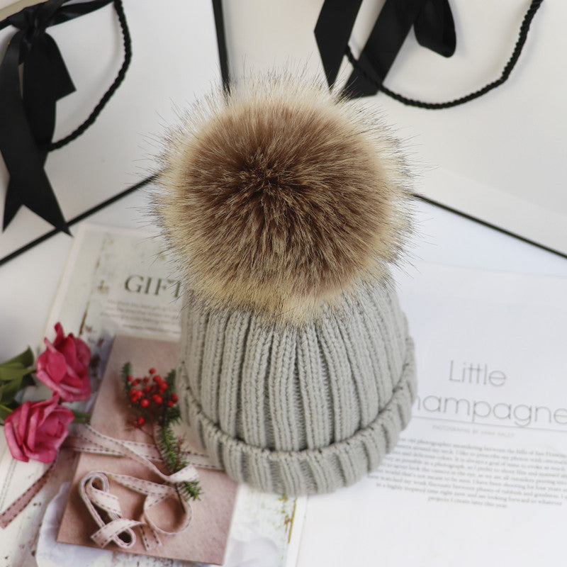 Classic cozy knit beanie with fluffy pom accent in neutral tone, snug feminine winter style