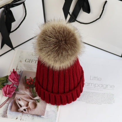 Classic cozy knit beanie with fluffy pom accent in neutral tone, snug feminine winter style