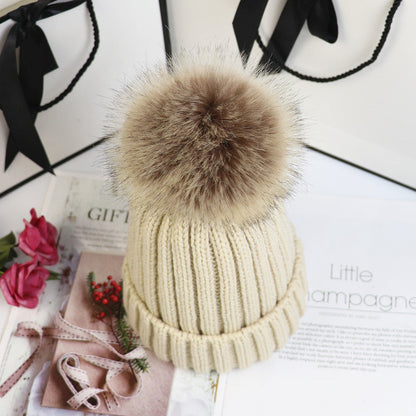 Classic cozy knit beanie with fluffy pom accent in neutral tone, snug feminine winter style