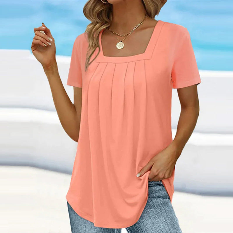 Elegant white pleated blouse with soft front pleats, relaxed fit, refined everyday style