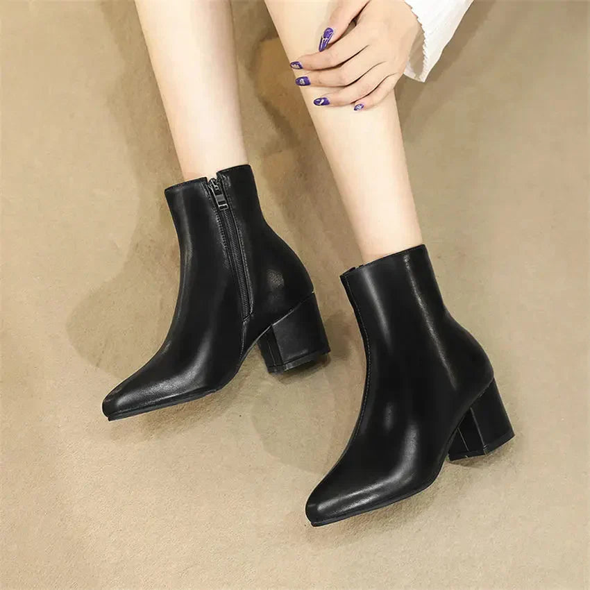 Women's metallic silver zip-up ankle boots with insulated lining and sleek modern finish
