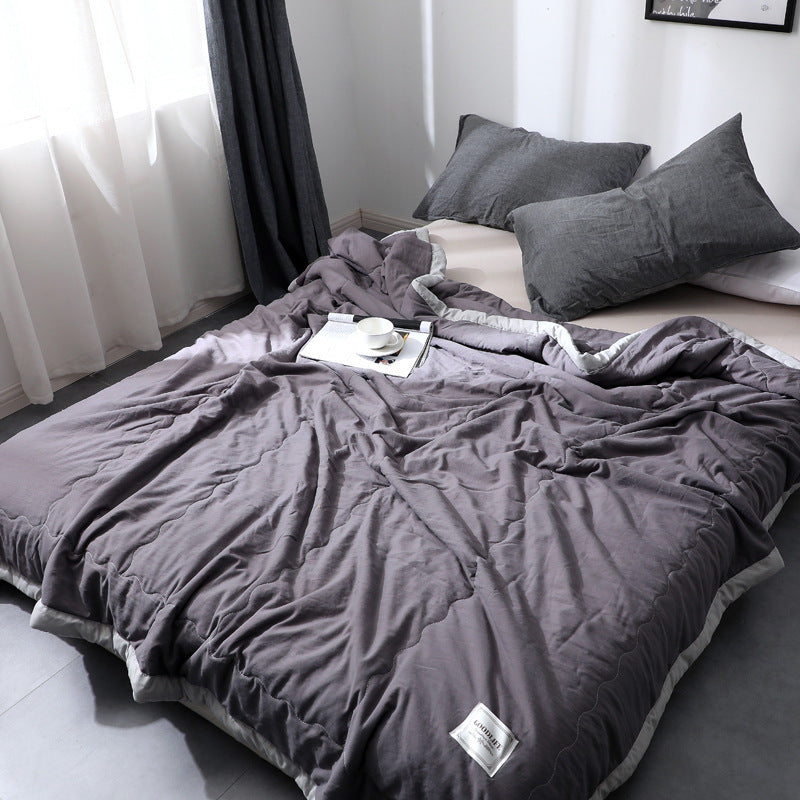Minimalist cotton quilt blanket in soft neutral tones, lightweight breathable all-season bedroom layer