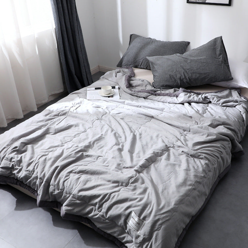 Minimalist cotton quilt blanket in soft neutral tones, lightweight all-season breathable texture
