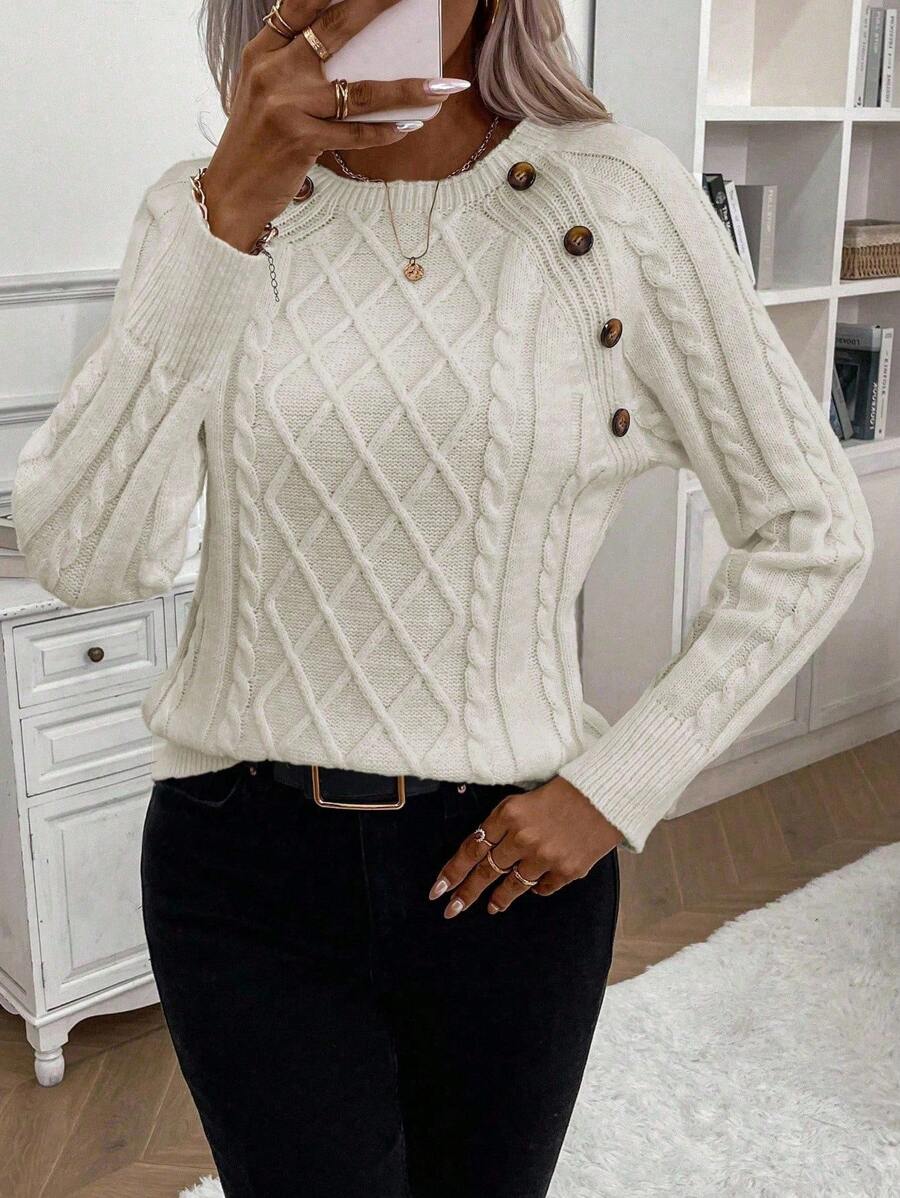 Cream cable-knit jumper with elegant button detail, cozy relaxed fit for winter warmth