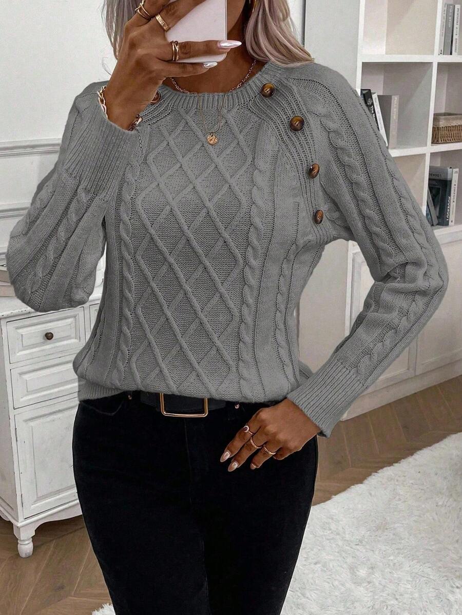 Cream cable-knit jumper with elegant button detail, cozy relaxed fit for winter