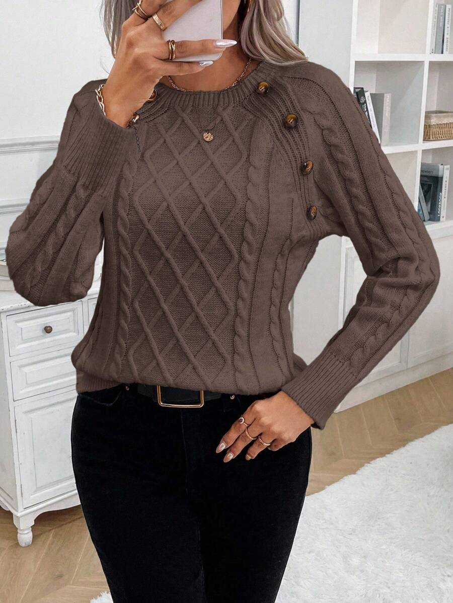 Cream cable-knit jumper with elegant button detail, cozy relaxed fit for cold weather