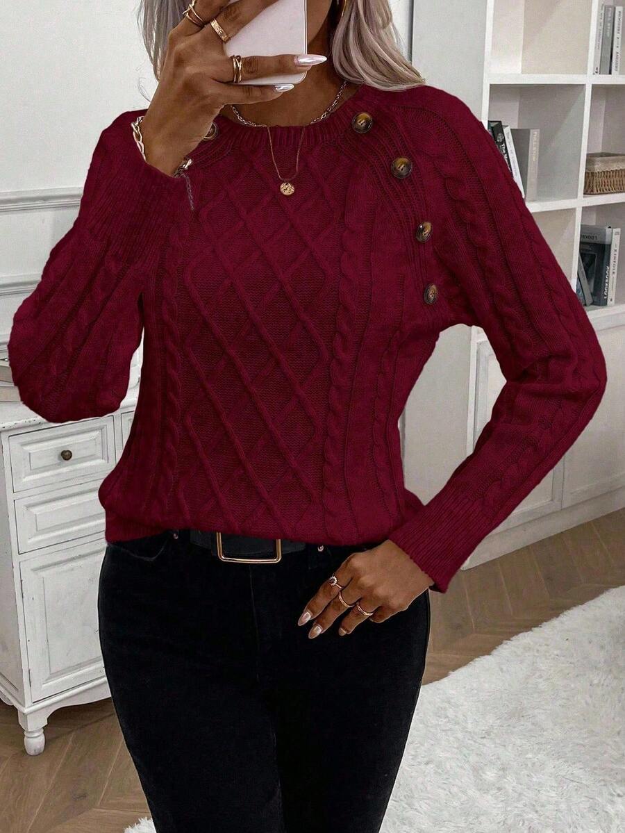 Cream cable-knit jumper with elegant button details, cozy relaxed fit for winter warmth