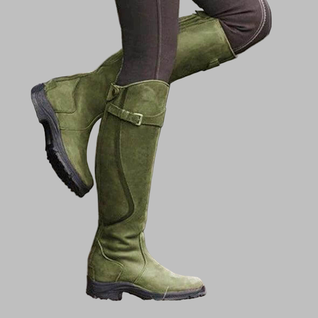 Women's knee-length distressed brown leather hiking boots with bold buckled strap design