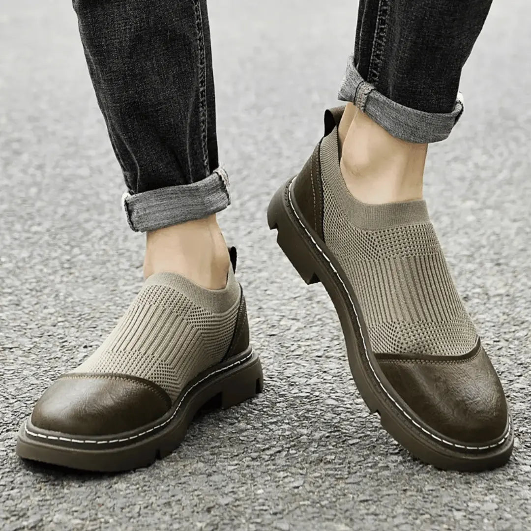 Black mesh ankle boots with sleek city-ready silhouette and artisanal woven construction