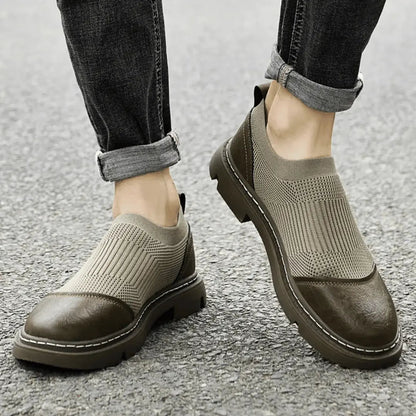 Black mesh ankle boots with sleek city-ready silhouette and artisanal woven construction
