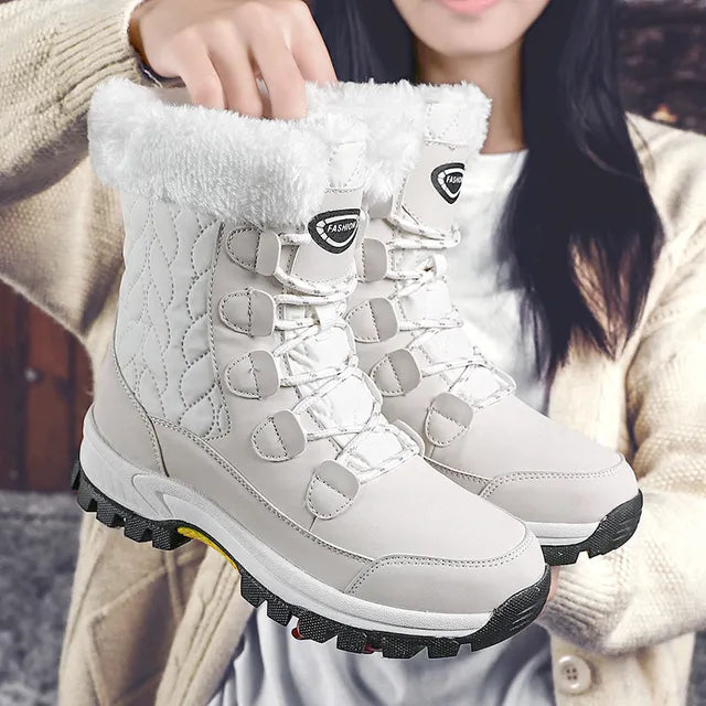 Women's mid-height quilted snow boots with faux fur trim and lace-up front, water resistant