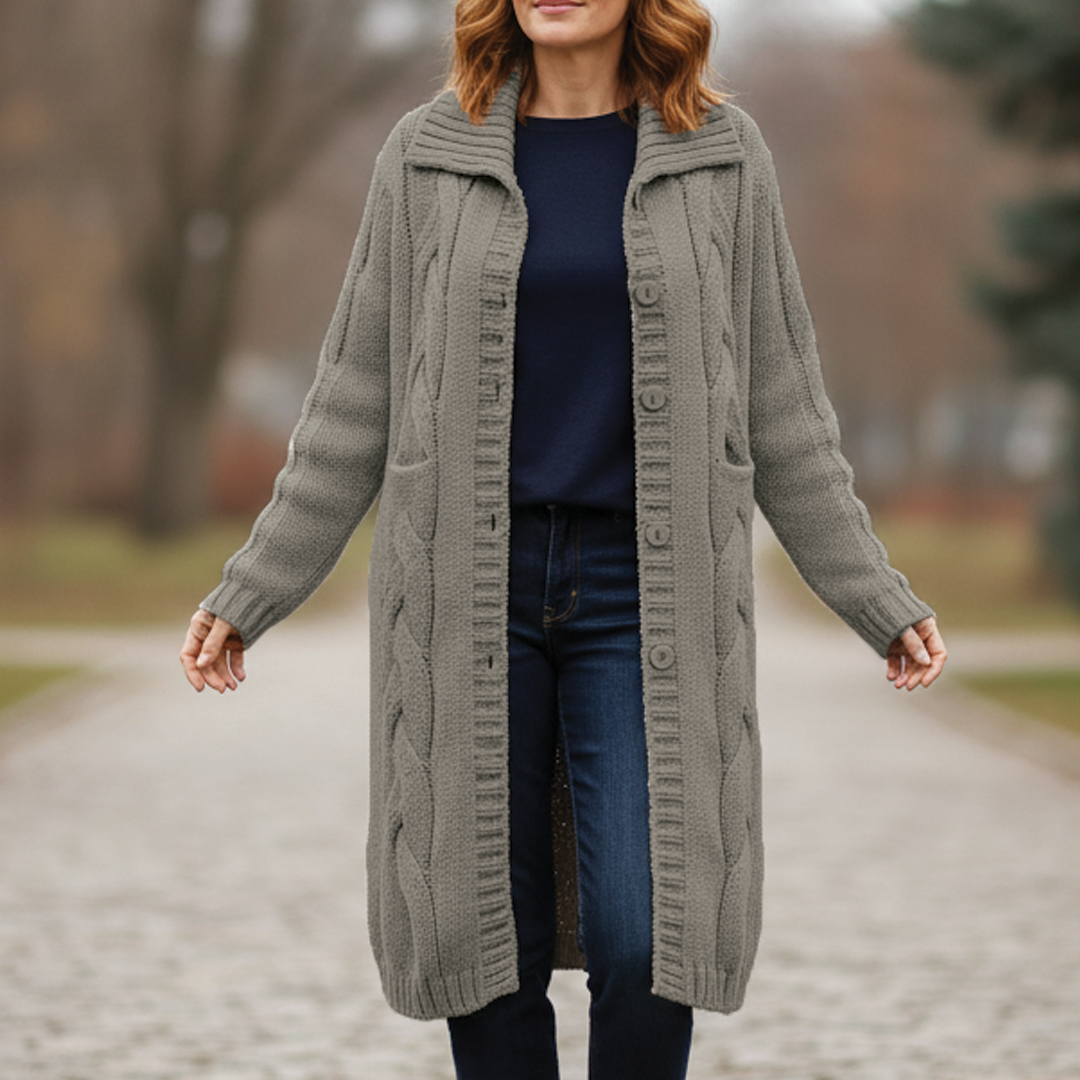 Ivory chunky cable-knit long coat with button closure, full-length silhouette for winter warmth