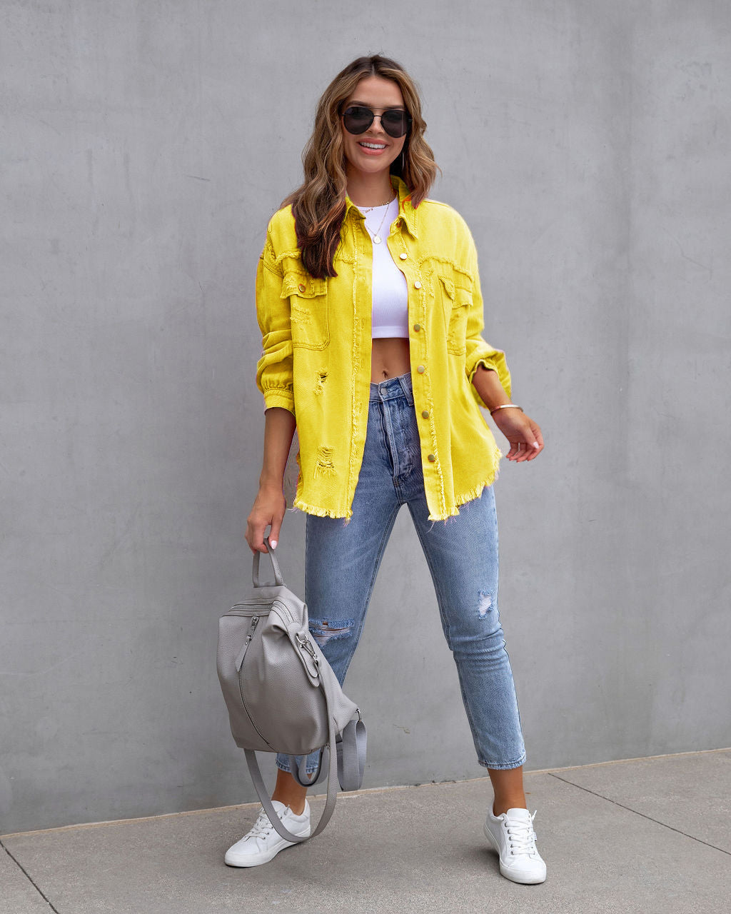 Women's oversized beige shirt jacket with relaxed urban fit and distressed detailing by Wavlynn