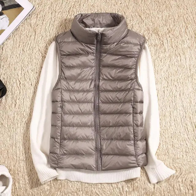 Women's lightweight quilted down vest with high collar, insulated slim fit for everyday layering