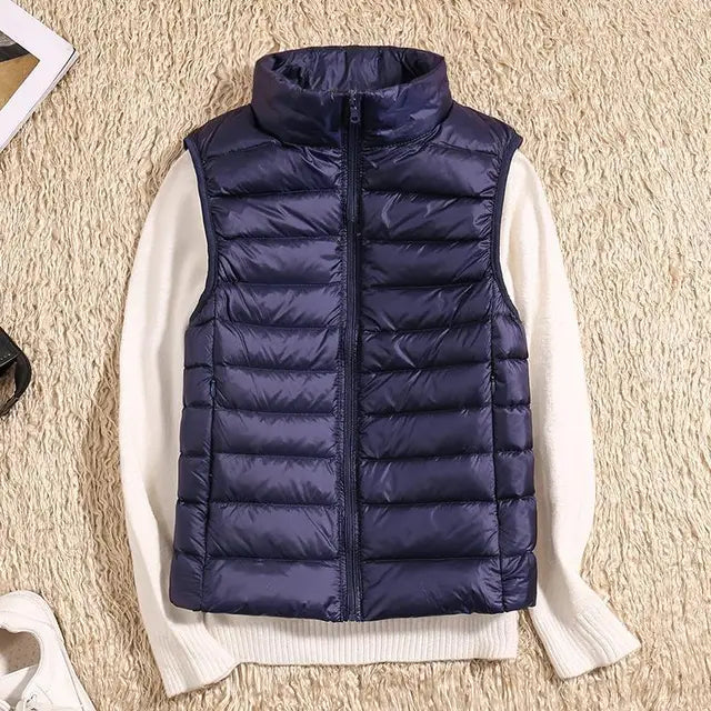 Women's lightweight quilted down vest with high collar, insulated slim fit for everyday layering