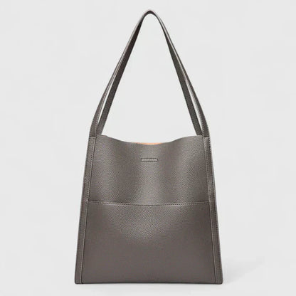Structured handbag in neutral tones with clean lines, spacious interior, and minimalist elegant design