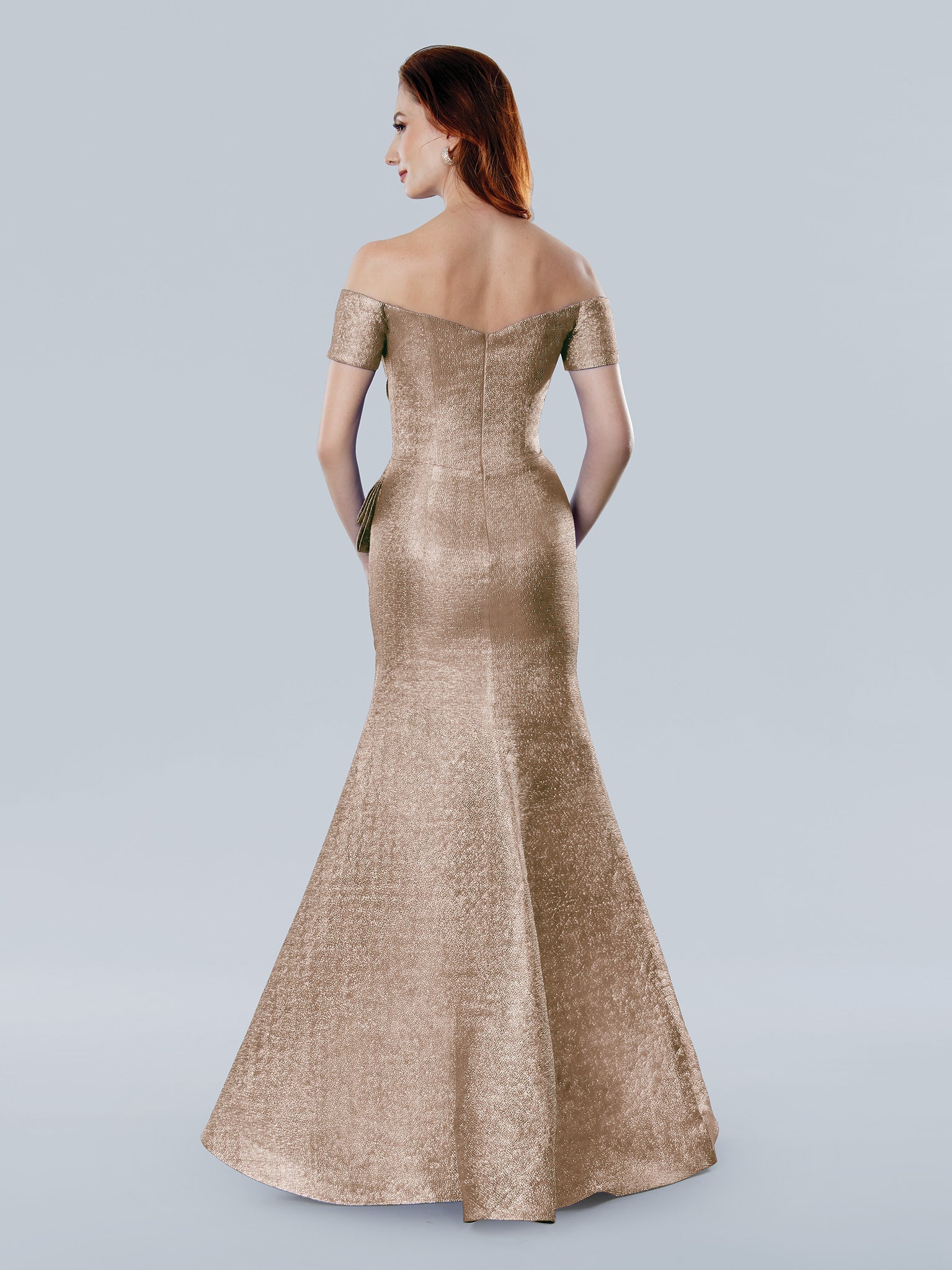 Metallic brocade mermaid evening gown with off-the-shoulder neckline and sculpted pleated bodice