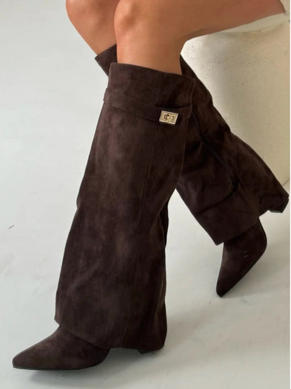 Women's black slouchy pointed toe thigh-high boots with relaxed drape silhouette