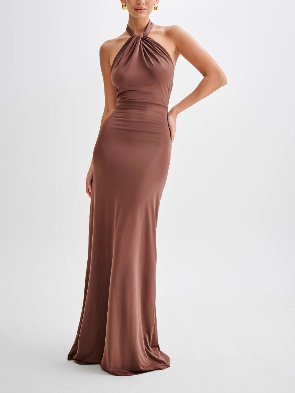 Slinky halter maxi dress with ruched detailing, curve-hugging silhouette, and dramatic low back cut