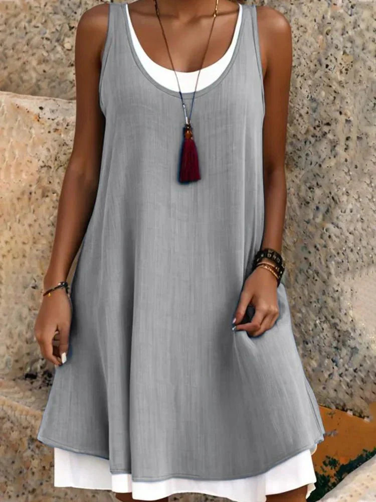 Women's sleeveless scoop neck layered mini dress in dark faux two-piece design with white underlayer