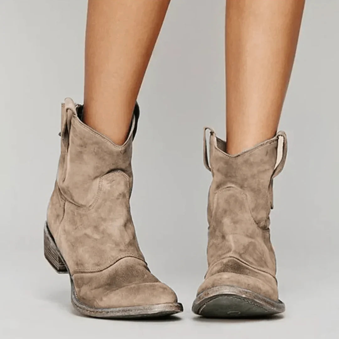 Soft blue suede Western curve boots with sculpted silhouette and pull tabs for easy wear