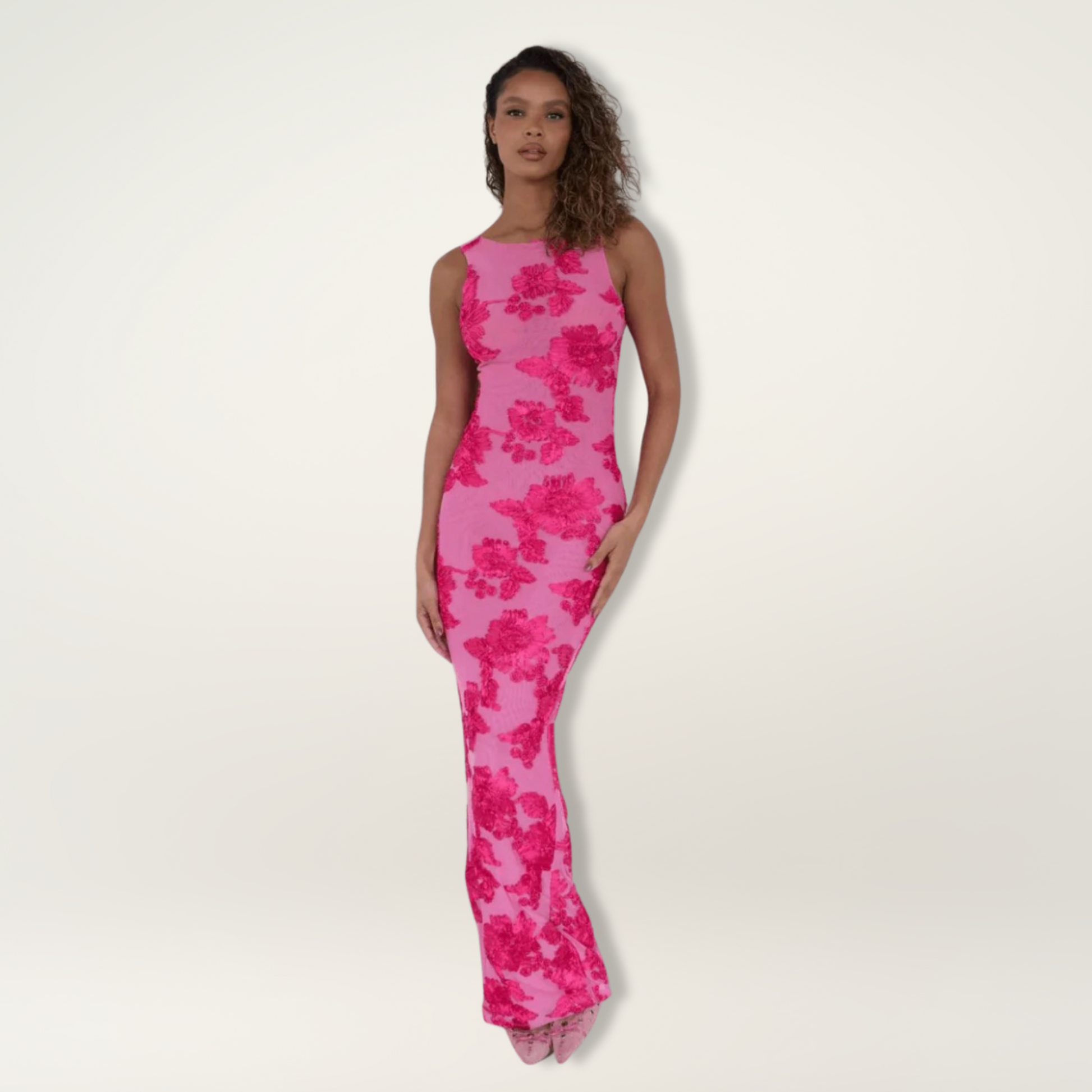 Elegant white maxi dress with soft pink floral design, flowing silhouette and waist-defining cut
