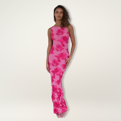 Elegant white maxi dress with soft pink floral design, flowing silhouette and waist-defining cut