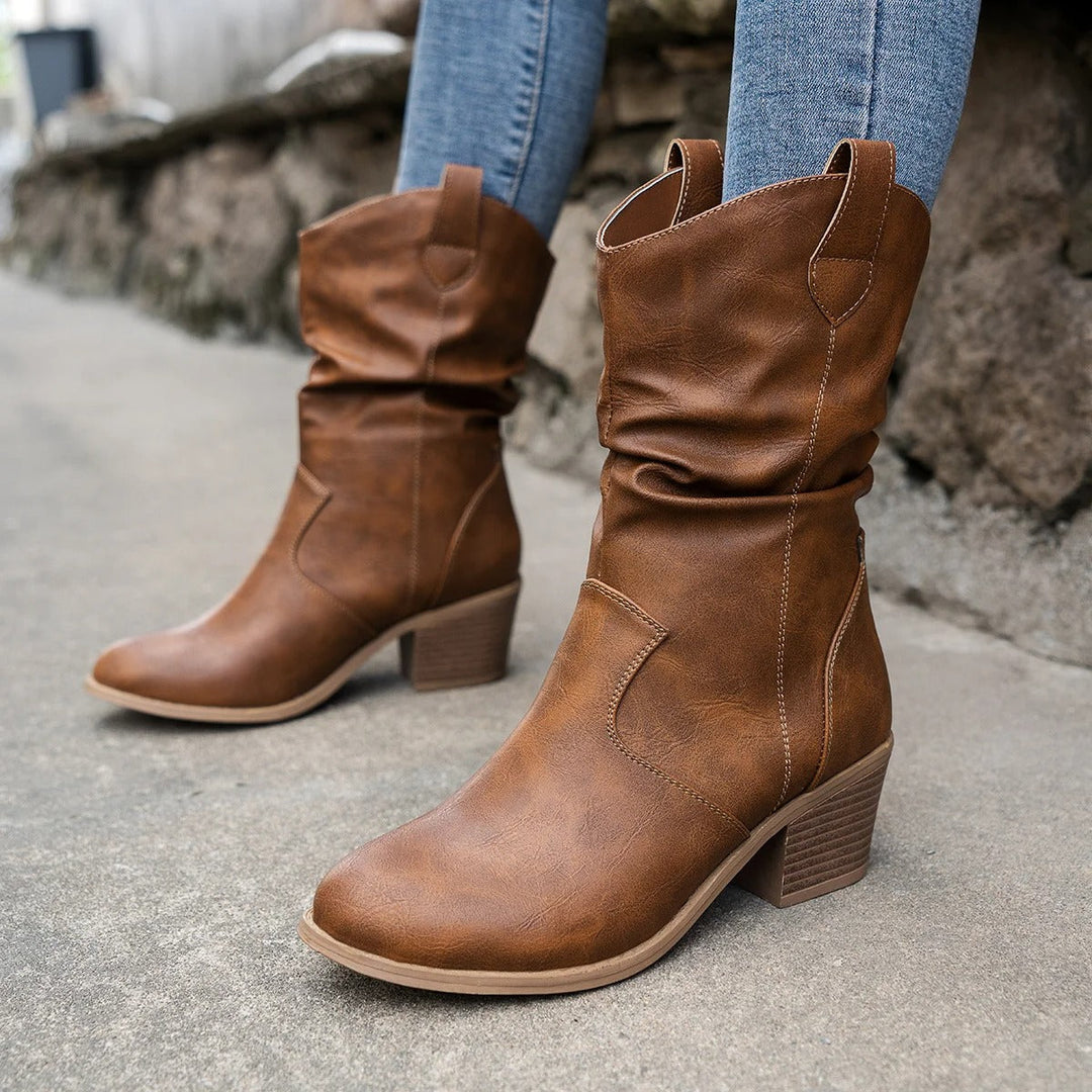 Women's winter cowboy heeled boots in sleek almond-toe silhouette with refined western stitching