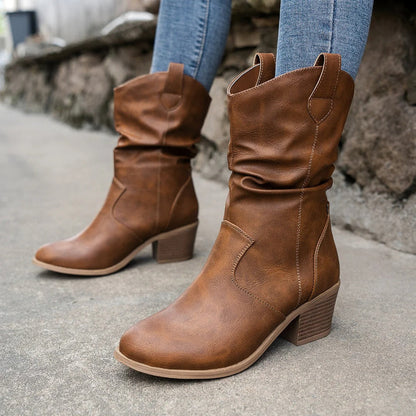 Women's winter cowboy heeled boots in sleek almond-toe silhouette with refined western stitching