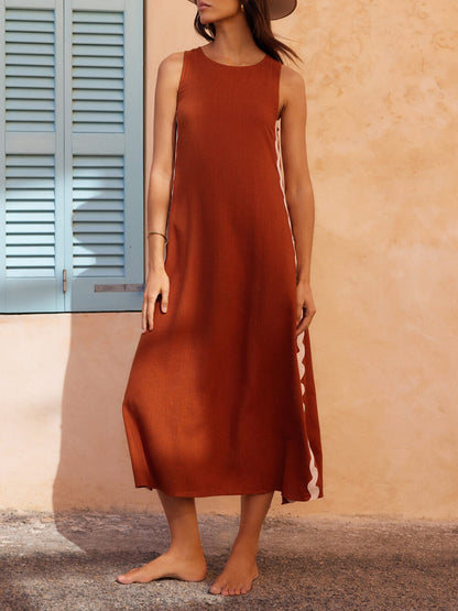 Black sleeveless midi dress with bold wavy contrast side trim, relaxed minimalist silhouette