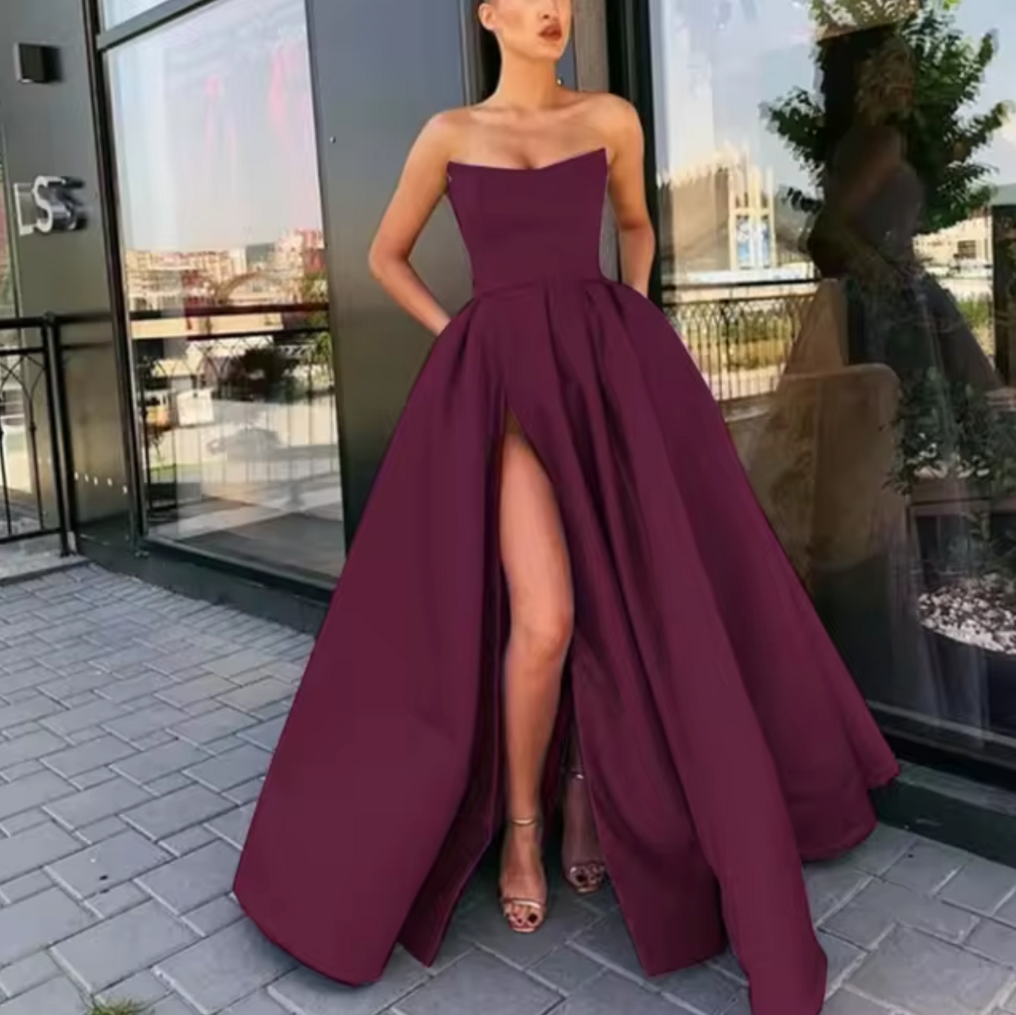 Black strapless A-line floor-length evening gown with high slit, elegant formal silhouette