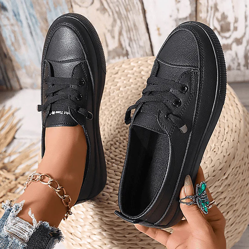 Women's white low-top lace-up sneaker with smooth faux leather upper, minimal casual style