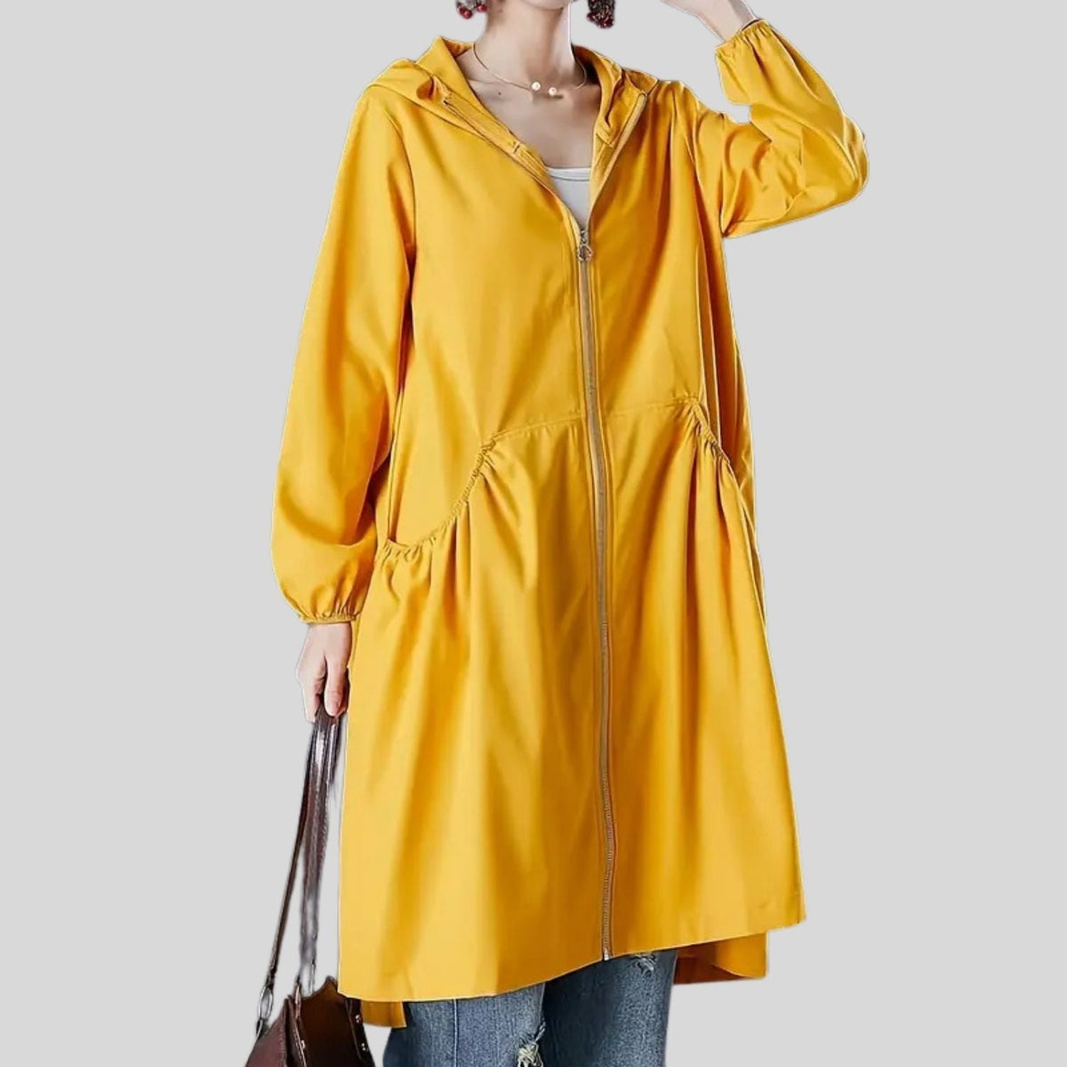 Women's long waterproof rain jacket with sealed seams for all-day dry protection and slim fit