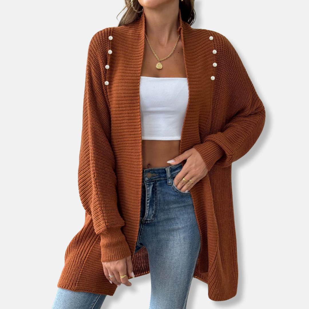 Women's longline shawl collar cardigan in neutral acrylic knit with elegant pearl button closure
