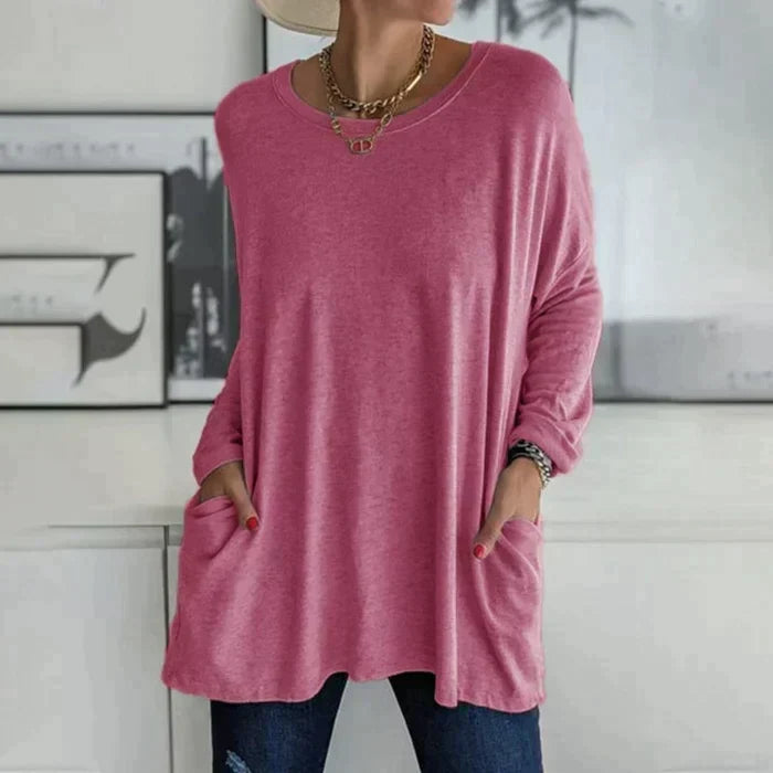 Women's oversized long sleeve tunic top with front pockets, relaxed knit fit and flared hem