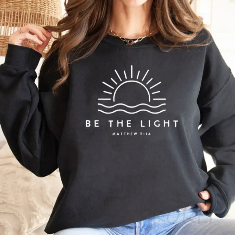 White women's pullover sweatshirt with minimalist Matthew 5:14 faith quote graphic