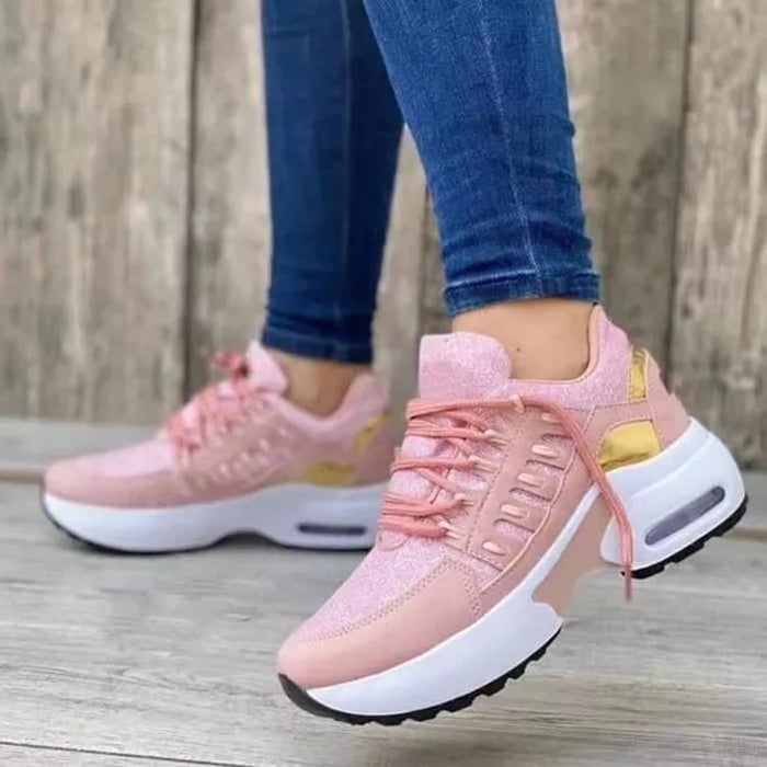 White chunky platform sneakers with gold-accented midsole, lace-up closure, and breathable mesh upper